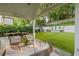 An open-air patio features comfortable seating, an outdoor dining area, and a manicured lawn for entertaining at 1201 Beech Valley Ne Rd, Atlanta, GA 30306