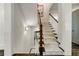 Staircase featuring dark wood floors, neutral carpet runner, and natural light at 1201 Beech Valley Ne Rd, Atlanta, GA 30306