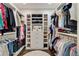 Well-organized walk-in closet featuring custom shelving and hanging racks on both sides at 1201 Beech Valley Ne Rd, Atlanta, GA 30306