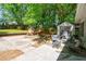 Inviting backyard featuring a patio, storage shed, playhouse, and lush green landscaping at 1314 Arkwright Se Pl, Atlanta, GA 30317