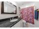 Well-lit bathroom featuring a single sink vanity, granite counters, and a shower with floral curtain at 1314 Arkwright Se Pl, Atlanta, GA 30317