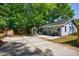 Wide shot of the backyard with a patio area, storage shed, and the back of the home at 1314 Arkwright Se Pl, Atlanta, GA 30317