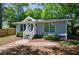 Charming home exterior with a welcoming front porch, manicured landscaping and ample natural light at 1314 Arkwright Se Pl, Atlanta, GA 30317