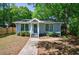 Charming single-story home features a beautifully landscaped front yard with mature trees at 1314 Arkwright Se Pl, Atlanta, GA 30317