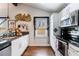 Modern kitchen featuring stainless steel appliances, granite countertops, and white cabinetry at 1314 Arkwright Se Pl, Atlanta, GA 30317