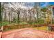 Spacious wooden deck overlooking a backyard full of trees and greenery at 1355 Compton Woods Dr, Loganville, GA 30052