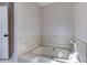 Bathroom featuring a large white tub and shower at 1355 Compton Woods Dr, Loganville, GA 30052