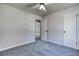 Bedroom with neutral paint, carpet, ceiling fan and ensuite access at 1355 Compton Woods Dr, Loganville, GA 30052
