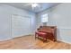 Bright room features wood floors, double closet, with piano and window unit at 1355 Compton Woods Dr, Loganville, GA 30052