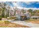 Charming two-story home featuring a covered carport and a welcoming front porch at 1355 Compton Woods Dr, Loganville, GA 30052