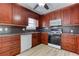 Updated kitchen featuring custom cabinets, modern appliances, and laminate floors at 1355 Compton Woods Dr, Loganville, GA 30052