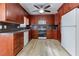 Well-lit kitchen with wooden cabinets, modern appliances and ceiling fan at 1355 Compton Woods Dr, Loganville, GA 30052