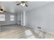 Living room boasts built-in shelves, ceiling fans, and carpet flowing into the laminate floor at 1355 Compton Woods Dr, Loganville, GA 30052