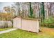 Backyard shed on green grass, featuring a concrete sidewalk leading up to it at 1355 Compton Woods Dr, Loganville, GA 30052
