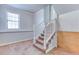 Carpeted staircase with white wooden railing, leading to upper level at 1355 Compton Woods Dr, Loganville, GA 30052