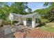 The wooden deck and lush backyard with string lights are ready for entertainment at 2129 Arlington Ne Ave, Atlanta, GA 30324
