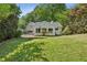 Expansive backyard featuring a well-maintained lawn and the rear view of the home at 2129 Arlington Ne Ave, Atlanta, GA 30324