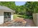 Inviting backyard with wooden deck, string lights, lush landscaping, and access to the house through glass doors at 2129 Arlington Ne Ave, Atlanta, GA 30324