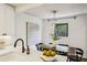 Dining area with a dark wood table, black chairs, and modern lighting fixtures at 2129 Arlington Ne Ave, Atlanta, GA 30324