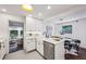 Bright kitchen featuring white cabinets, stainless steel appliances, and an adjacent dining area at 2129 Arlington Ne Ave, Atlanta, GA 30324