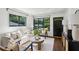 Beautiful living room with hardwood floors, recessed lighting, neutral furniture and black framed windows and doors at 2129 Arlington Ne Ave, Atlanta, GA 30324