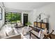 Stylish living room featuring hardwood floors, recessed lighting, and neutral furniture, plus a black trimmed window at 2129 Arlington Ne Ave, Atlanta, GA 30324