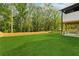 Beautifully manicured backyard with lush green grass and a wooden fence bordering the property at 2977 N Bogan Rd, Buford, GA 30519