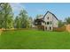 Expansive backyard featuring lush green grass and a charming home exterior at 2977 N Bogan Rd, Buford, GA 30519