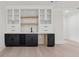 Loft wet bar with a marble backsplash, custom cabinets, and wine storage at 2977 N Bogan Rd, Buford, GA 30519