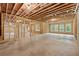 Unfinished basement features exposed rafters and concrete flooring, providing a blank canvas at 2977 N Bogan Rd, Buford, GA 30519