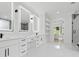 Bright bathroom featuring dual sinks with quartz countertops, open shelving, and walk-in shower at 2977 N Bogan Rd, Buford, GA 30519