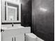 Powder room with a dark accent wall, a modern vanity, and a sleek white toilet at 2977 N Bogan Rd, Buford, GA 30519