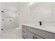 Modern bathroom featuring a glass walk-in shower and a gray vanity with black hardware at 2977 N Bogan Rd, Buford, GA 30519