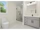 Modern bathroom with a gray vanity, a glass-enclosed shower, and a bright window at 2977 N Bogan Rd, Buford, GA 30519