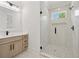 Bright bathroom featuring a marble-tiled shower with a glass door and a modern vanity at 2977 N Bogan Rd, Buford, GA 30519