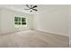 Spacious bedroom with light hardwood floors, a large window, and a modern ceiling fan at 2977 N Bogan Rd, Buford, GA 30519