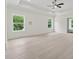 Spacious bedroom featuring tray ceilings, ceiling fan, and two windows providing lots of natural light at 2977 N Bogan Rd, Buford, GA 30519