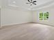 Spacious bedroom featuring tray ceilings, ceiling fan, and a window providing lots of natural light at 2977 N Bogan Rd, Buford, GA 30519