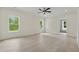 Bright bedroom with hardwood floors, recessed lighting, and windows overlooking a green yard at 2977 N Bogan Rd, Buford, GA 30519