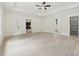 Spacious bedroom featuring tray ceilings, ceiling fan, and access to a walk-in closet at 2977 N Bogan Rd, Buford, GA 30519