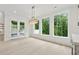 Bright dining area featuring large windows, an elegant chandelier, and a double glass door at 2977 N Bogan Rd, Buford, GA 30519