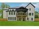The home's exterior features a covered deck and manicured lawn surrounded by a wooden fence at 2977 N Bogan Rd, Buford, GA 30519