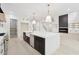 Bright kitchen showcasing a large island, stainless steel appliances, and open layout connected to the living area at 2977 N Bogan Rd, Buford, GA 30519