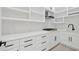 Modern kitchen featuring white cabinets, marble backsplash, and stainless steel appliances at 2977 N Bogan Rd, Buford, GA 30519