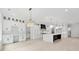 Bright kitchen with expansive custom cabinets and shelving, large island, stainless appliances, adjacent to dining area at 2977 N Bogan Rd, Buford, GA 30519