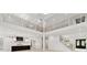 Grand two-story living room features a loft, a chef's kitchen, and an open floor plan, perfect for entertaining at 2977 N Bogan Rd, Buford, GA 30519