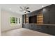 Living room with custom built-in shelves and cabinets, recessed lighting, and hardwood floors at 2977 N Bogan Rd, Buford, GA 30519