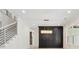 Open-concept living room boasts recessed lighting, hardwood floors, and a sophisticated black accent wall with modern light fixture at 2977 N Bogan Rd, Buford, GA 30519