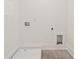 This unfurnished utility room features light-colored walls and flooring with modern fixtures at 2977 N Bogan Rd, Buford, GA 30519