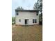 Exterior rear view of home with sliding glass door and a grass backyard at 4752 Browns Mill Ferry Rd, Lithonia, GA 30038